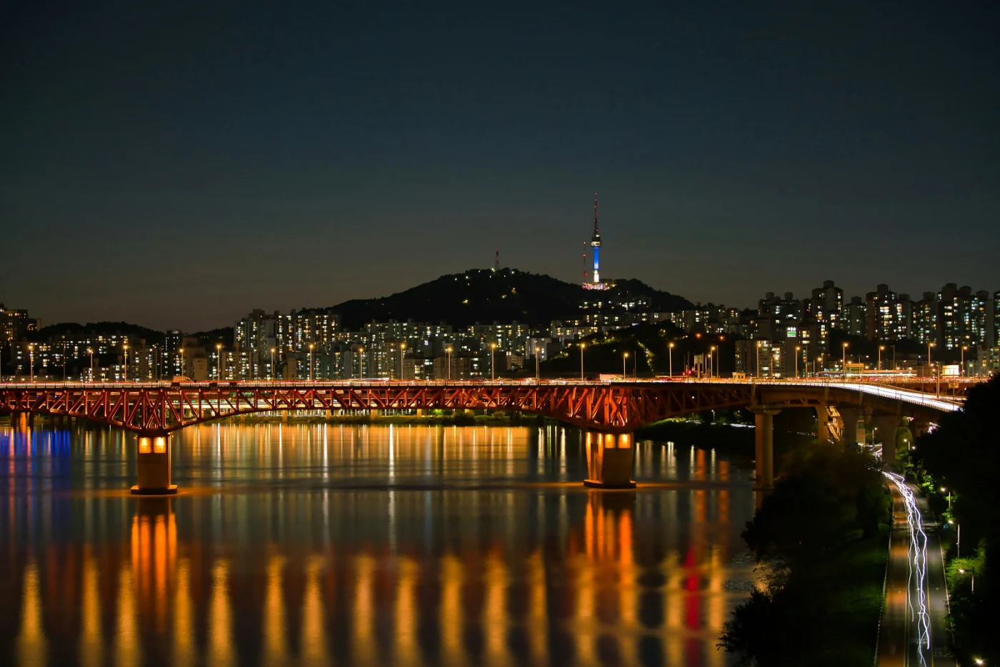 Seoul at night from the Han River: Seongsu Bridge lit up, N Seoul Tower on Namsan behind
